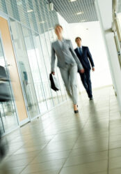 Businesspeople,Going,Along,Corridor,Inside,Office,Building